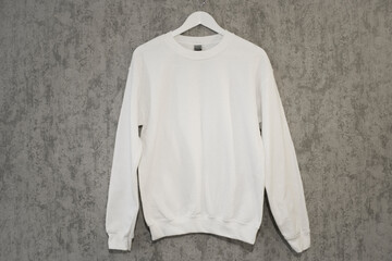 White sweatshirt blank mockup on a hanger on the grey background
