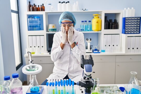 Brunette Woman Working At Scientist Laboratory Rubbing Eyes For Fatigue And Headache, Sleepy And Tired Expression. Vision Problem