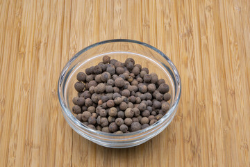Allspice pepper closeup on wooden background