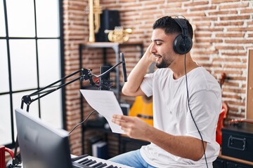 Young arab man artist singing song at music studio