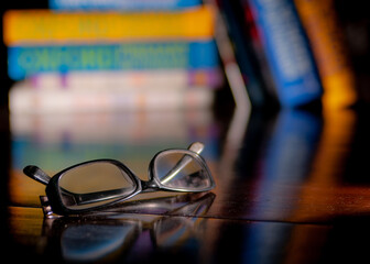 glasses with blurred books on the background