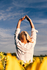 guy in a blouse on a background of sunflowers