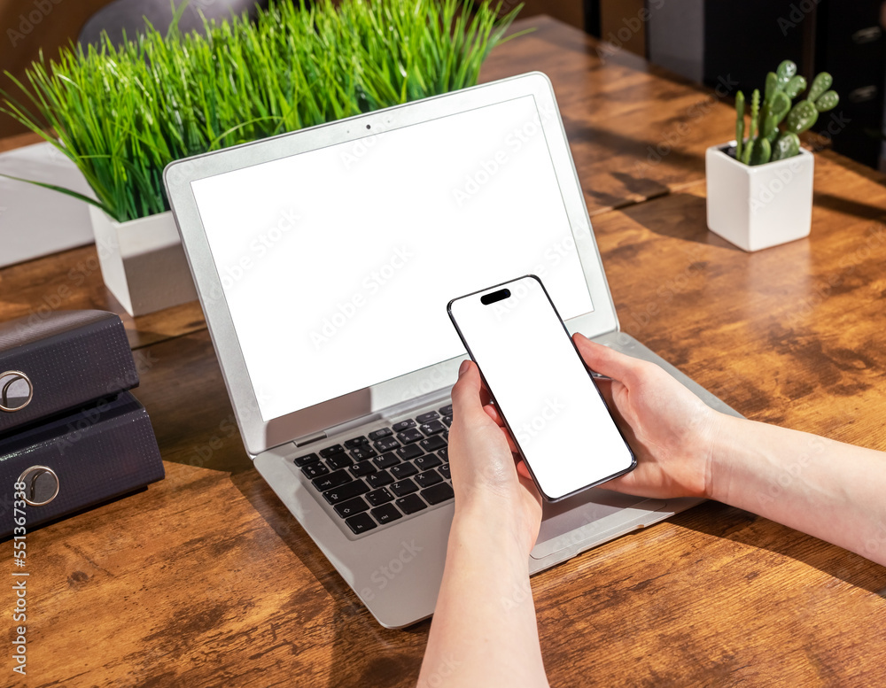 Poster laptop and smartphone mockups. hand holding mobile phone mock up for app ad and pc display on office