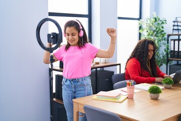 Mother and daughter working and recording dance video at office