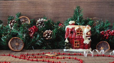 Santa climbed on the roof of the house to give gifts to children, festive decor for the New Year, Christmas card.