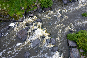 aerial photography view of a mountain river with stones and water