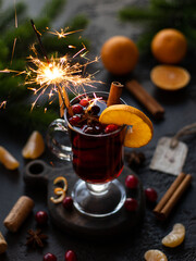 Mulled red wine with oranges, mandarines, cranberry, cinnamon and anise. Tall glass with handle on...