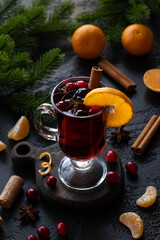 Mulled red wine with oranges, mandarines, cranberry, cinnamon and anise. Tall glass with handle on...