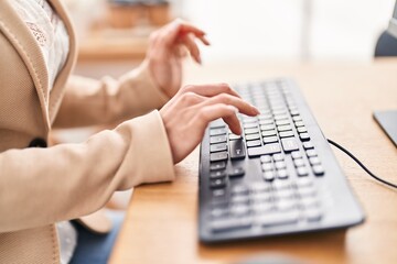 Young blonde woman business worker using keyboard at office