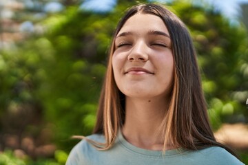 Adorable girl smiling confident breathing at park