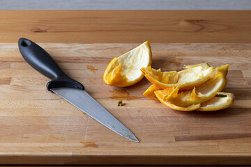 Sliced and eaten orange with a knife