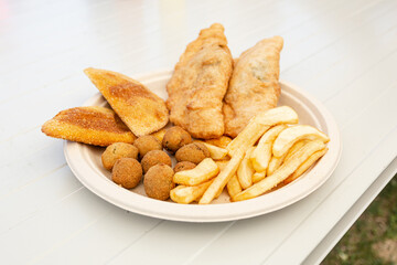 Vegan fried. Half-moons stuffed with tomato and vegan cheese, french fries and Ascolana olives. Olive all'ascolana are a typical dish from the Marche region