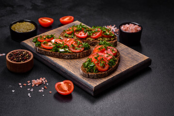 Tasty bruschetta with tomatoes, mozzarella, basil, spices and herbs