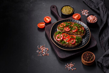 Tasty bruschetta with tomatoes, mozzarella, basil, spices and herbs