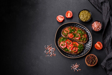 Tasty bruschetta with tomatoes, mozzarella, basil, spices and herbs