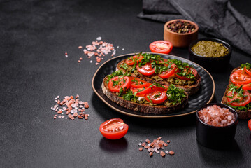 Tasty bruschetta with tomatoes, mozzarella, basil, spices and herbs