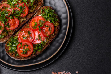 Tasty bruschetta with tomatoes, mozzarella, basil, spices and herbs