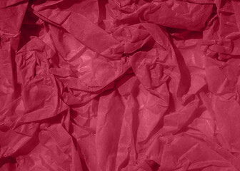 Crumpled paper Viva Magenta color of the year 2023. Texture crumpled paper for text or design with Copy space. Viva Magenta color paper.