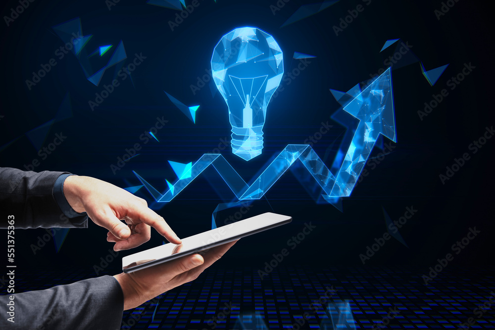 Poster close up of businessman hand pointing at tablet with abstract glowing polygonal light bulb and arrow