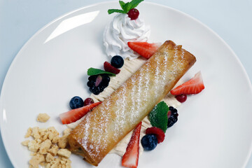 traditional apple strudel with whip cream and fresh mix berries