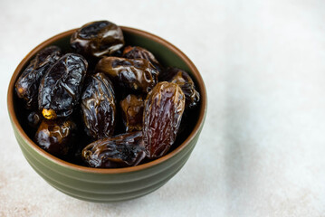 Dates fruit in bowl on white background. Dried organic Superfood.