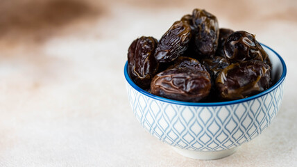 Dates fruit in bowl on white background. Dried organic Superfood.