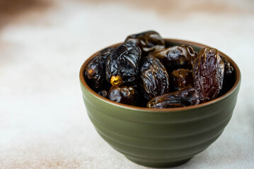 Dates fruit in bowl on white background. Dried organic Superfood.