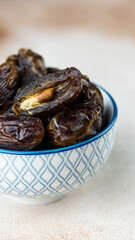 Dates fruit in bowl on white background. Dried organic Superfood.