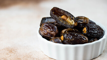 Dates fruit in bowl on white background. Dried organic Superfood.