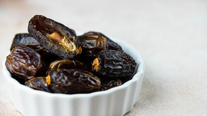 Dates fruit in bowl on white background. Dried organic Superfood.