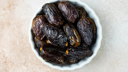 Dates fruit in bowl on white background. Dried organic Superfood.