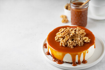 Nut caramel cake, cheesecake on white background, close up,