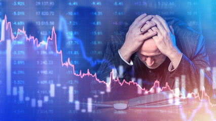 Frustrated investor. Man trader grabs head. Bankrupt businessman. Falling charts near investor....