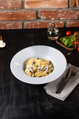 Italian Pasta Bolognese on a white plate with ingredients on a dark background. restaurant menu