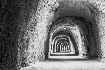 Illuminated Mountain Tunnel. The long tunnel for a poster, calendar, post, screensaver, wallpaper, postcard, banner, cover, website. Black and white high quality photo