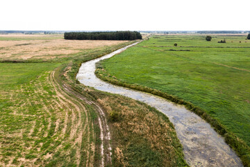 Rural landscape, fields, meadows, streams view from the drone.