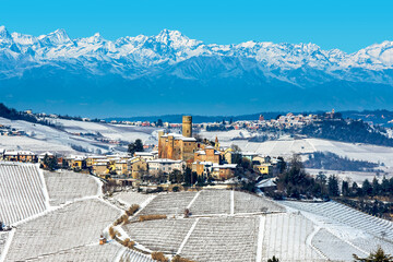 Small town on the hill covered with the snow in Piedmont, Italy.
