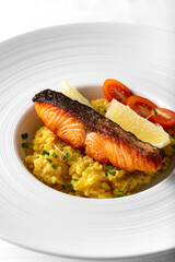 grilled salmon with saffron rice on a large white plate