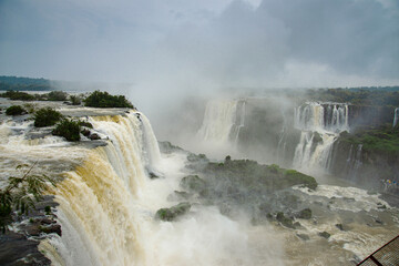 Iguazu Falls with tourists on a rainy day
