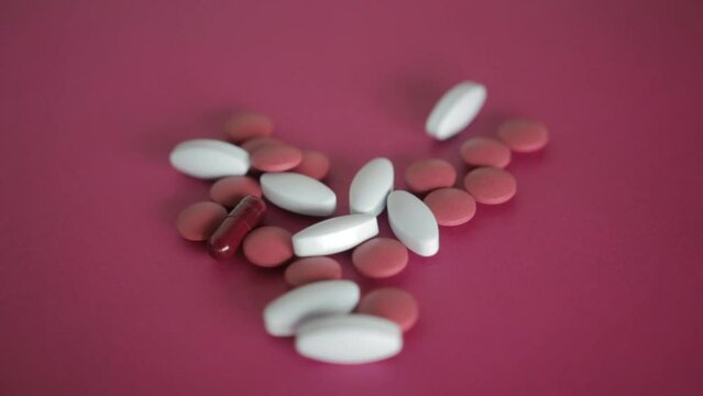 A man collect Pills and capsules on a colorful surface in a stochastic way
