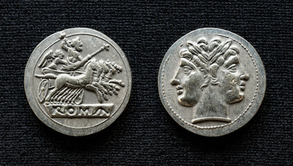 Ancient Roman coin showing Jupiter on horses and two-headed god Janus, 225-214 BC. Vintage silver...