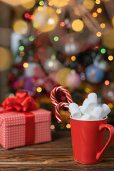 Christmas background with a Christmas tree, hot chocolate and marshmallows. Selective focus.