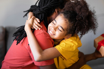 Father's Day. Happy Preteen Black Girl Embracing Her Dad At Home
