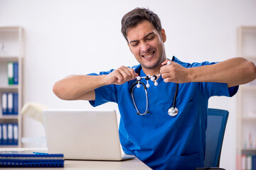 Young male student doctor holding molecular model