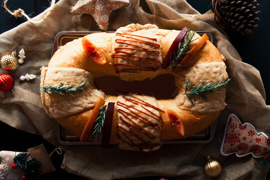 Top view of a traditional rosca de reyes, on black background. Mexican food. 