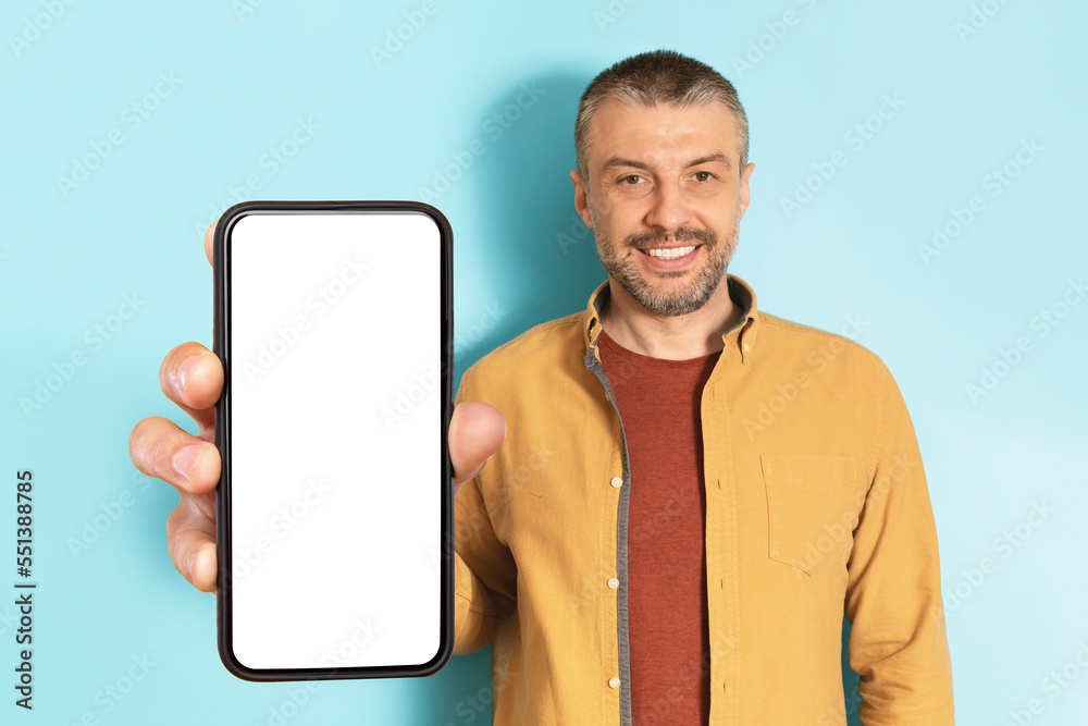 Poster app advertisement. happy mature man showing big white empty smartphone screen, recommending website 