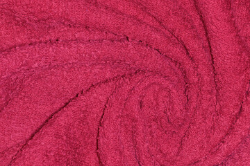 Fototapeta na wymiar Crumpled fabric texture of towel close up in Viva Magenta - trendy color of year 2023.