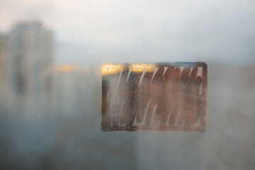 frames rectangle on foggy glass of city window with raindrops