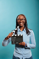 Happy joyful smiling heartily woman with movie clapboard being excited about being production...