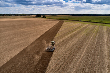 plowing farm after harvesting with vehicle